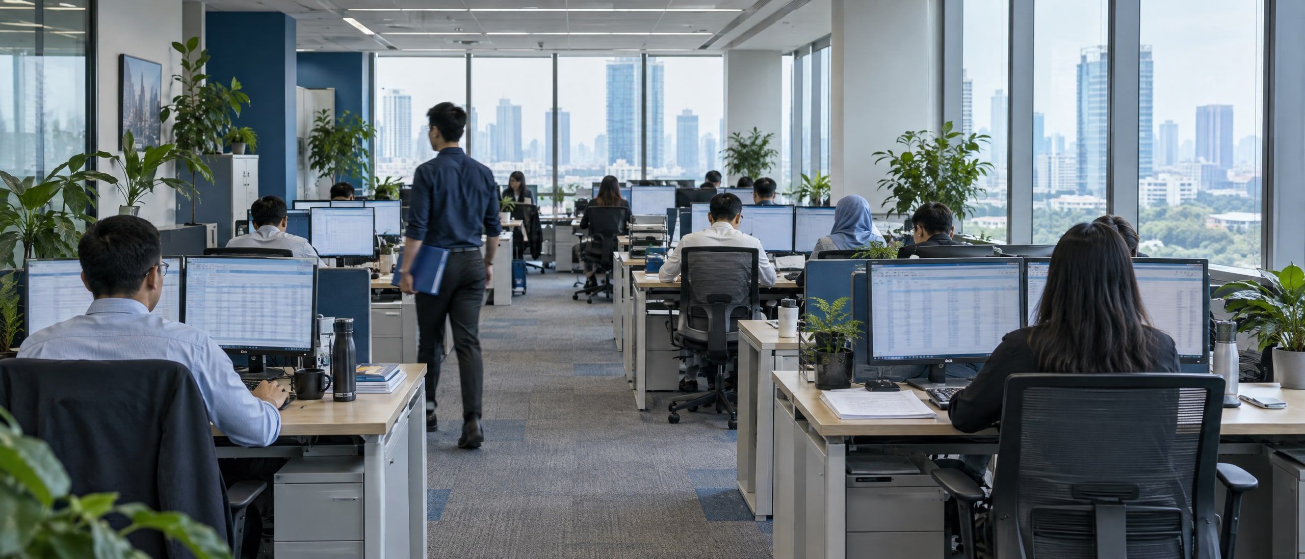 An open-plan finance office in Jakarta with accountants at their desks